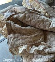 Full view of bed cover showing lace overlay, ruffled edges