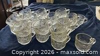 Group shot of all 24 clear glass punch cups on dark cloth