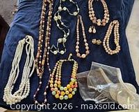 Group shot of all necklaces, earrings, and galoshes laid out