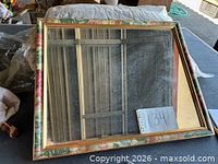 Front view showing mirror glass and floral frame