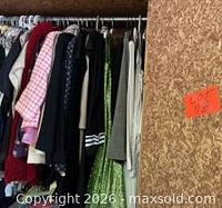 Clothing rack left side showing mixed garments