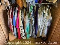 Full closet view of assorted hanging garments