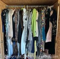 Full closet view of hung garments