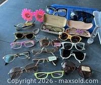 All eyewear, cases and stand laid out on table