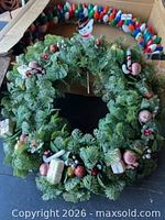 Full view of decorated green wreath with snowman pick