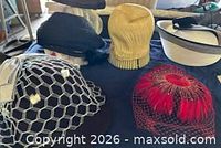 Group of five vintage women's hats on table