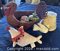 Overview: wicker turkey basket, two glass ornaments, Hallmark plush seal, ceramic lampshade, white dove ornament