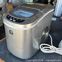 Full view of silver Igloo ice maker showing exterior condition and power cord