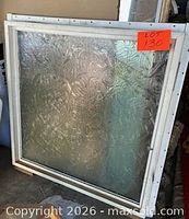 Front view of square white vinyl window with textured acrylic pane