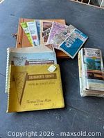 Group shot showing all atlases, scrapbook and folded maps