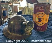 Helmet and lamp alongside National Carbide tin