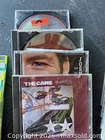 Stacks of CDs showing front covers of The Cars, Josh Groban and others