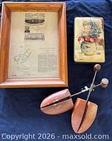Group view of framed patent, shoe forms, tin