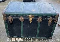 Front view showing black panels, green trim and brass hardware