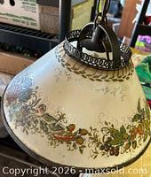 Full view of conical floral plastic shade with metal trim