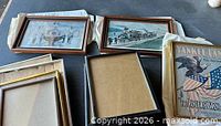 Group shot of three framed prints with five empty frames