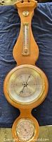 Full view of the wooden wall weather station showing thermometer, barometer, hygrometer