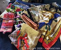 All scarves spread out showing variety of patterns and colors