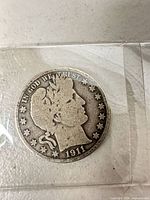 Obverse of 1911 Barber half dollar showing date and IN GOD WE TRUST motto