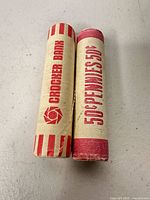 Two bank-wrapped penny rolls, showing wrapper text