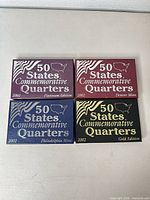 Front view of four boxed quarter sets: Platinum, Denver, Philadelphia, Gold editions