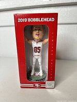 Front view of boxed George Kittle bobblehead