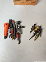 Group of mixed drill bits and accessories on table