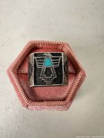 Front view showing thunderbird design and turquoise inlay