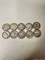 All 11 dimes laid out obverse side up