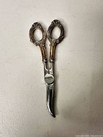 Full view of serving scissors showing sterling handles and steel blades