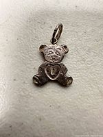 Front view of teddy bear pendant showing design and jump ring