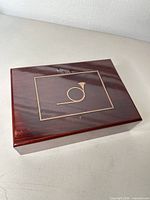 Closed jewelry box showing top with horn motif