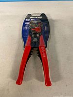 Front view of packaged wire stripper showing tool and branding