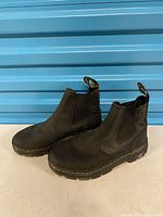 Full view of both boots showing overall condition, leather, elastic panels, and yellow stitching