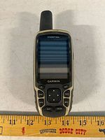 Front view of Garmin GPSMAP 64sx showing screen, buttons and size reference