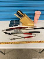 Group shot showing knife block with knives, loose knives, BBQ tools, and Polder scale