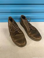 Oblique view of both boots showing uppers, laces, general wear