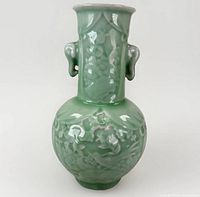 Front view showing celadon glaze, relief decoration, twin handles