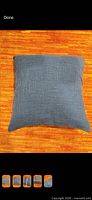 Full front view of blue pillow on orange background