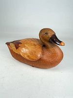 front view of woven bamboo duck basket showing glass eyes and beak
