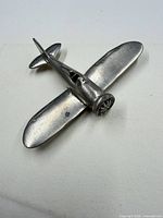 Top view of aluminum airplane brooch