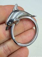 Close-up of silver dolphin keyring showing design and clasp