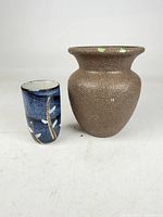 Sake cup and painted vase side by side showing size and exterior finishes.