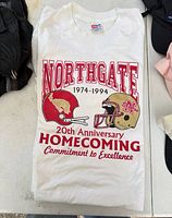 Front view of white Jerzees Northgate Homecoming T-shirt laid flat showing full graphic print