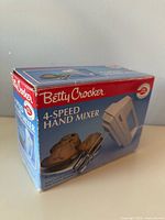 Retail box front showing Betty Crocker 4-Speed Hand Mixer branding