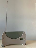 Front view showing mirrored display, silver housing and extended antenna