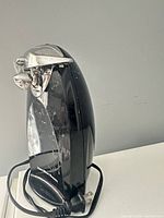 Front and side view of Hamilton Beach black electric can opener showing blade assembly and overall condition