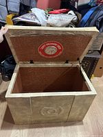 Ottoman open showing interior, vent label, hinges