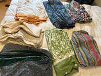 All seven duvet covers laid out on bed