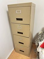 Front view of beige 4-drawer metal filing cabinet